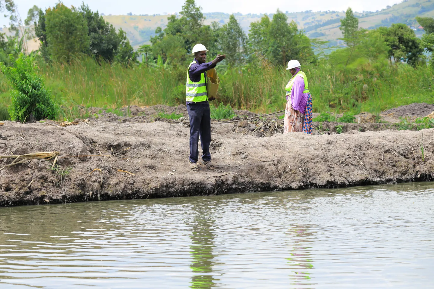 man standing next a fish pond