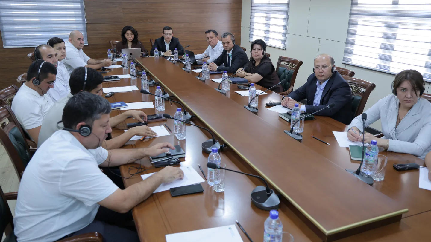 Participants seated around a conference table during a seminar