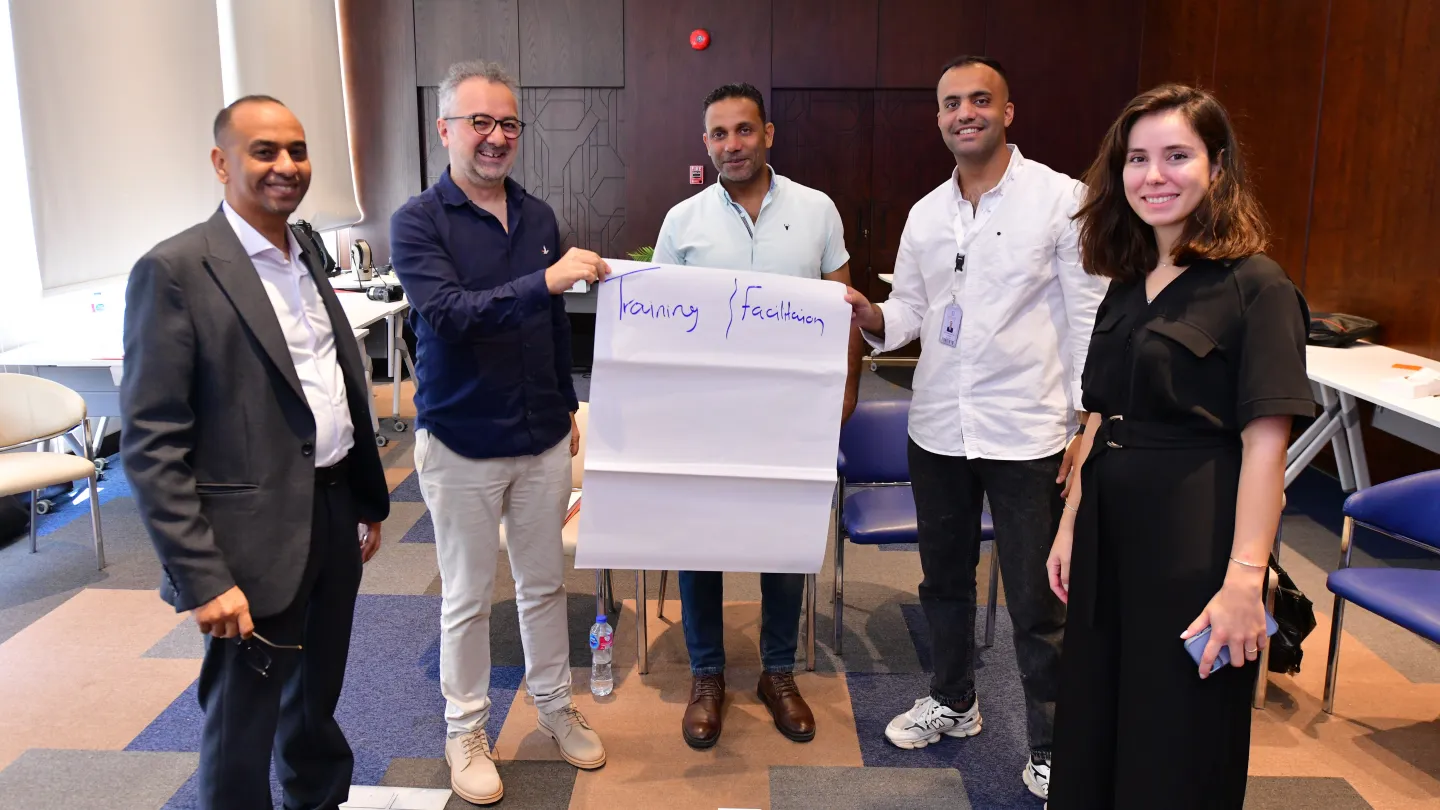 Factory Ambassador programme participants pose together during a Better Work Egypt training session.