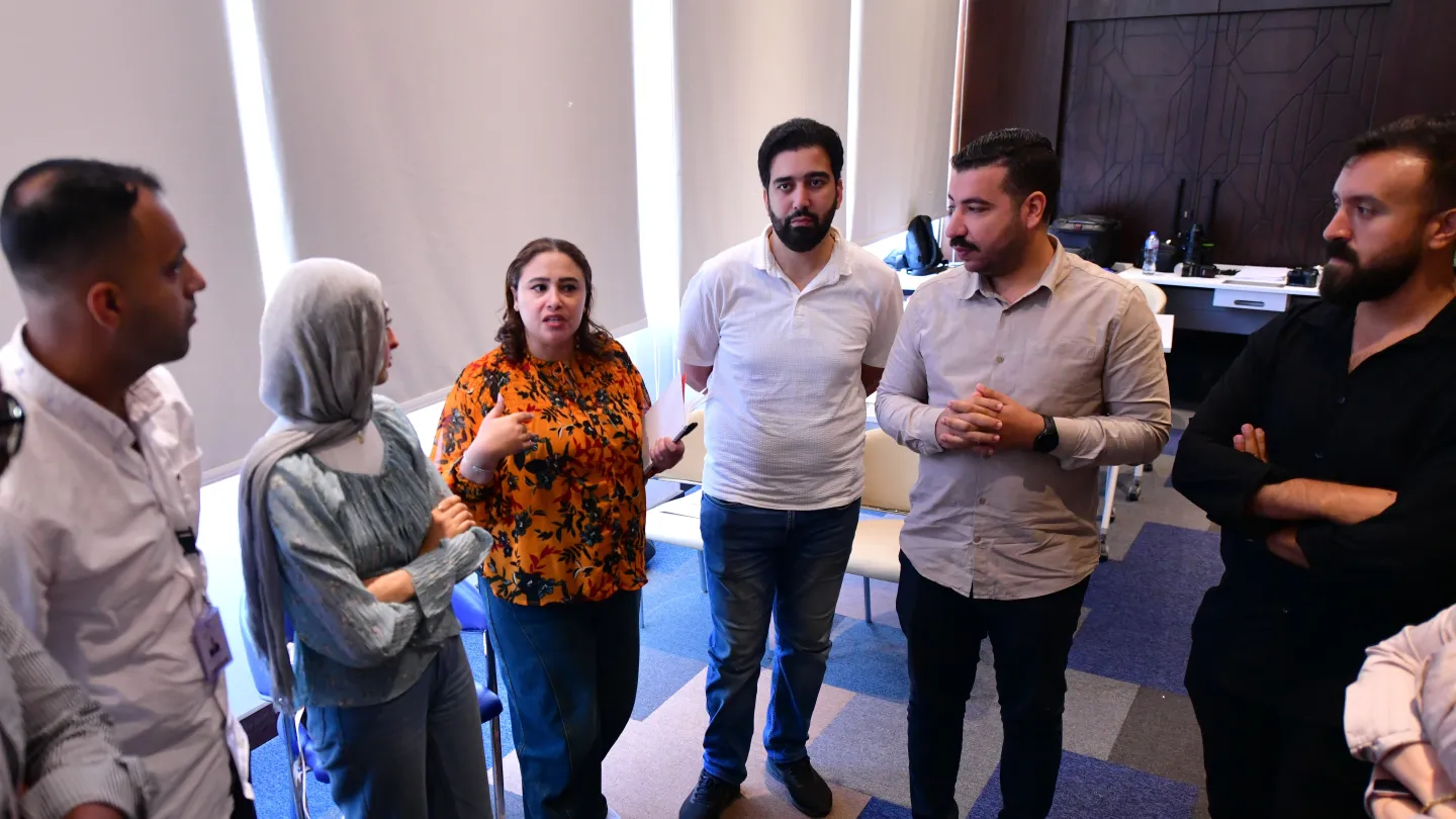 Factory Ambassador participants take part in a group exercise during Better Work Egypt training.