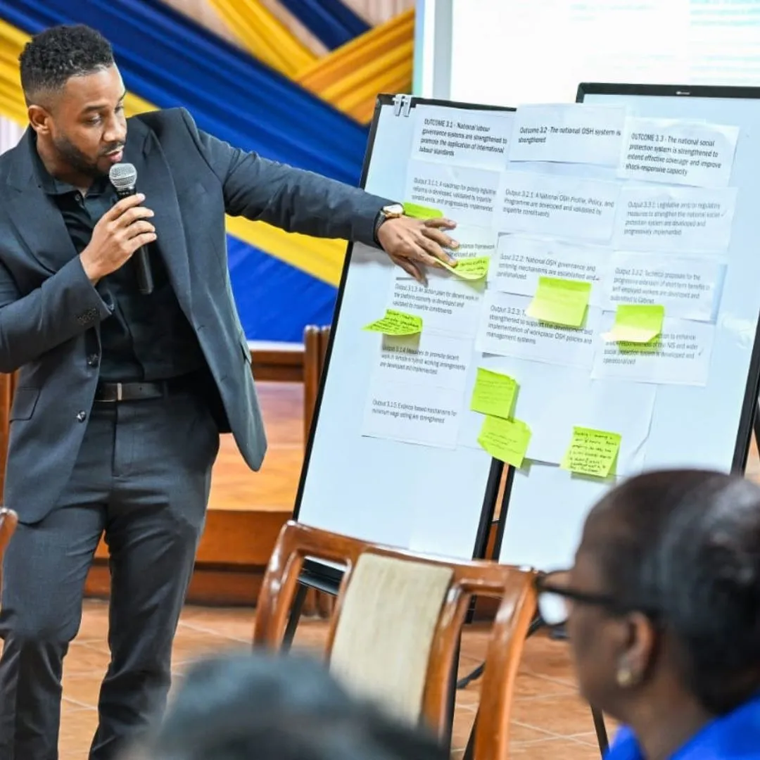 Man holding mic pointing to whiteboard