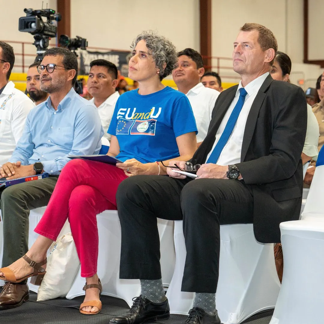 Three people- two men one woman sitting in a function