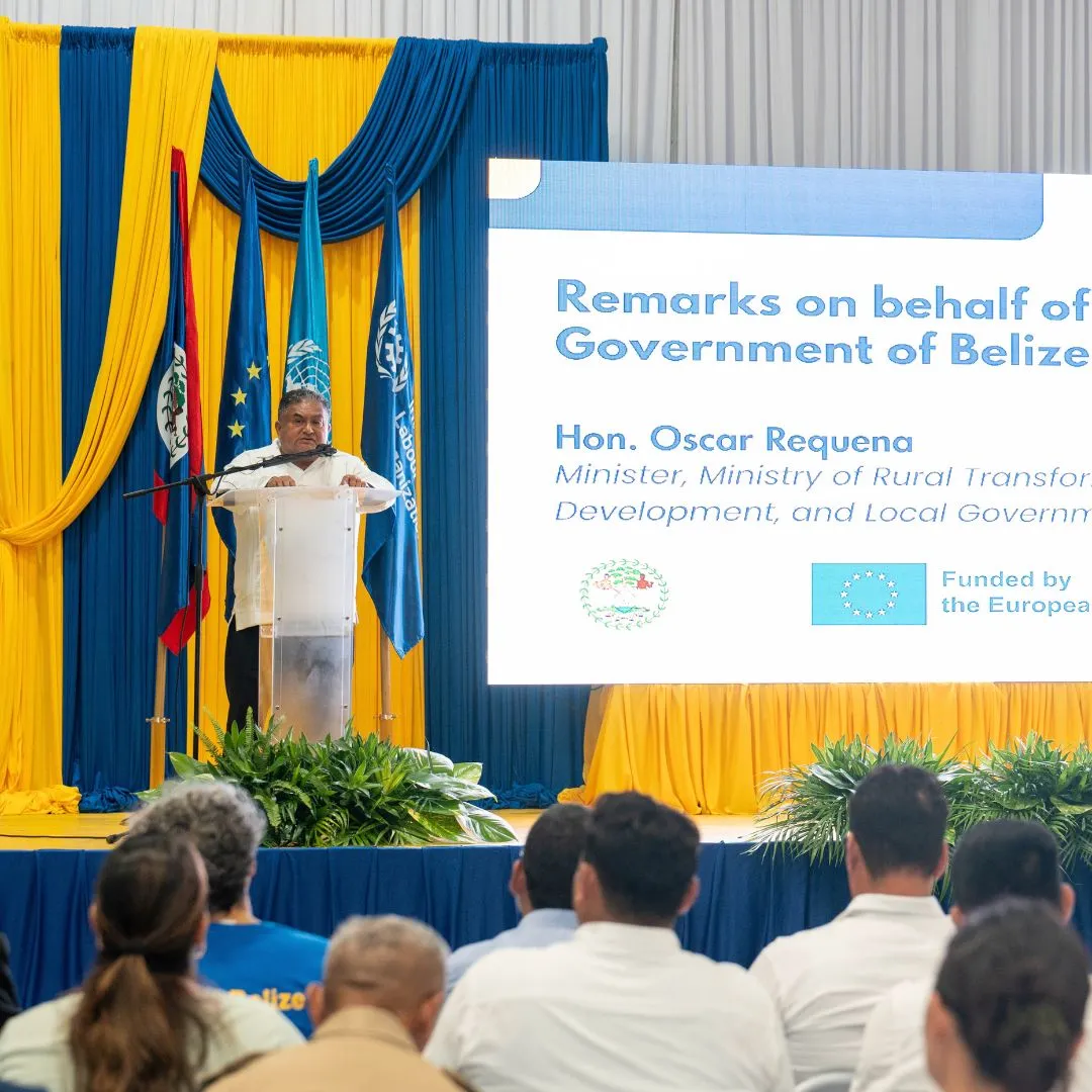 Man standing at podium with sign to his right