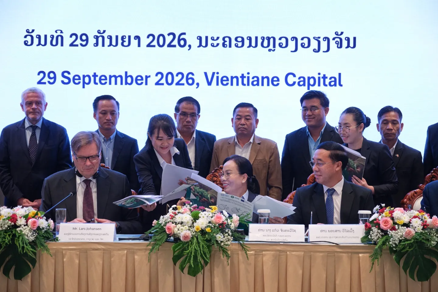 Representatives exchange documents during a formal signing ceremony in Vientiane Capital, Lao PDR, on 29 September 2026.