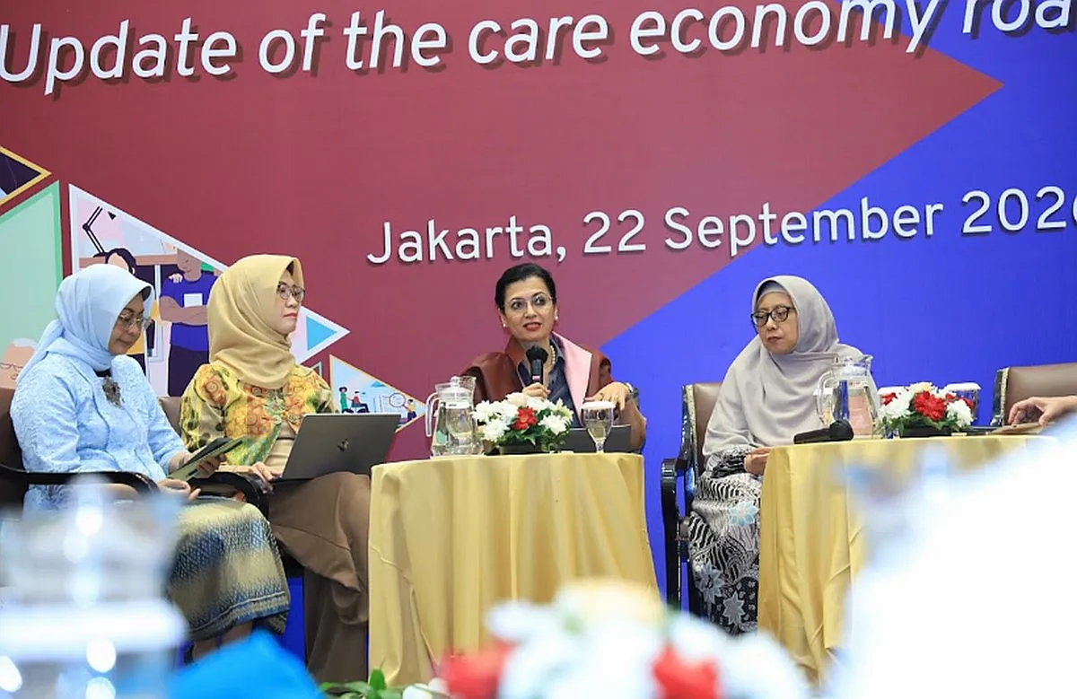 Four people sitting on the stage as speakers