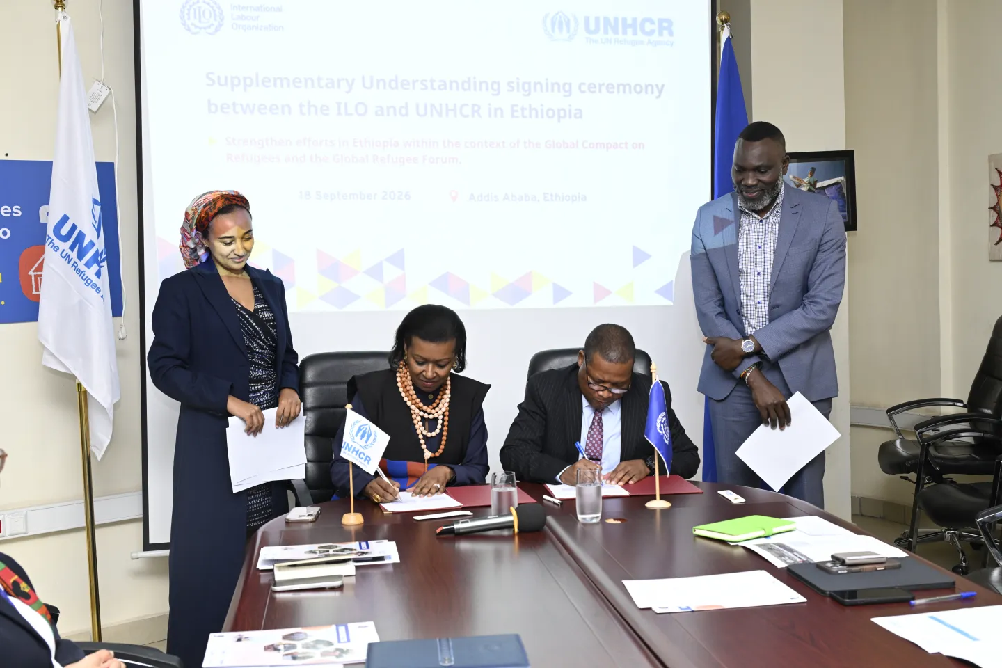 Officials signing documents 