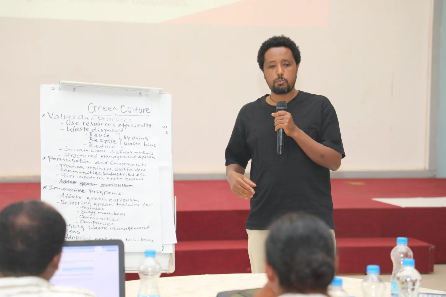 A participant presenting in front of fellow trainees