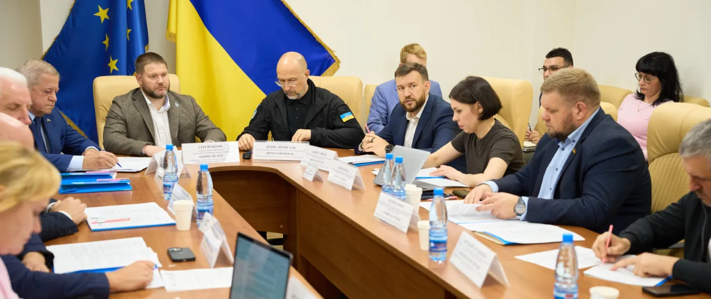 Men and women around a conference table