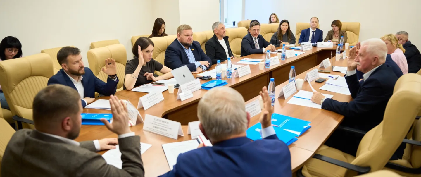 Men and women around a conference table 