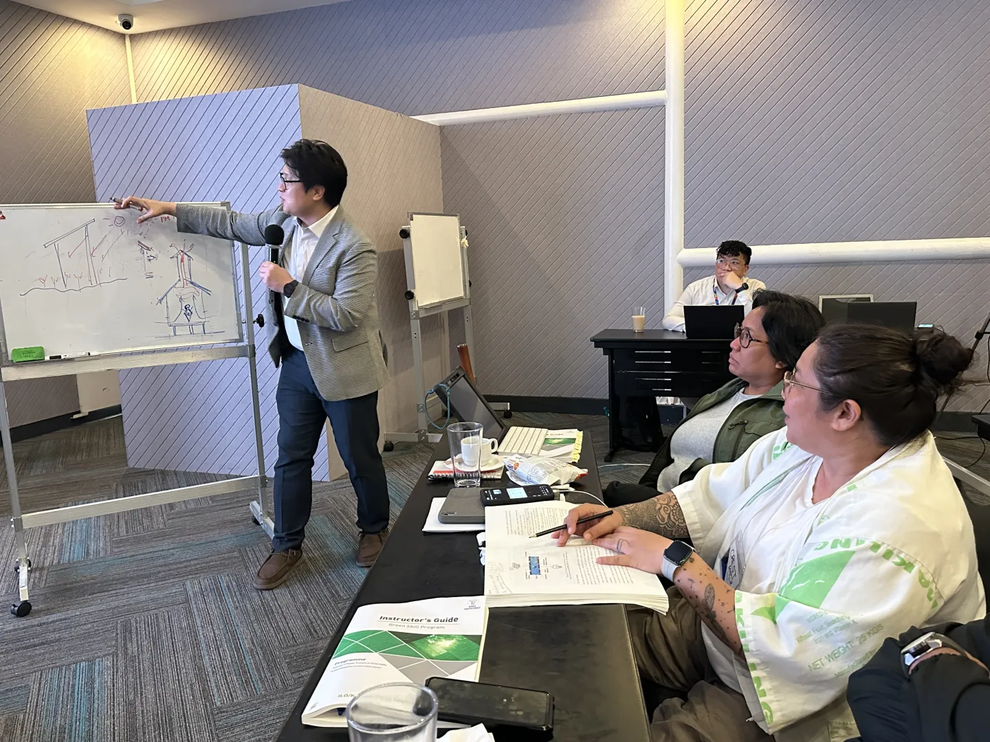 Michelle listens as experts from Korea Polytechnic University explain fundamental concepts and techniques in green building.