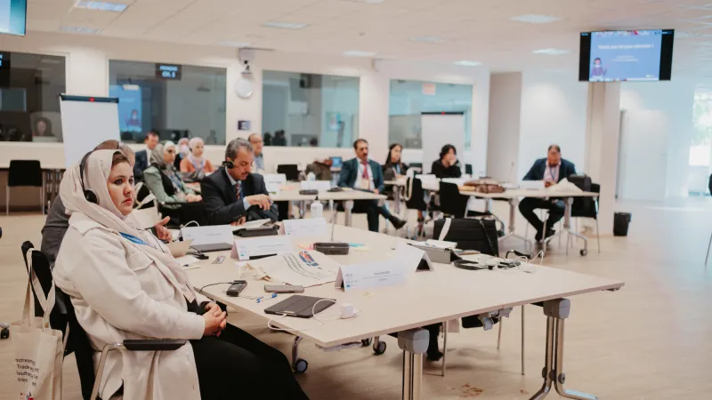 Participants at an event sitting at tables