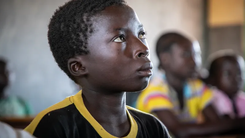 Young boy in a class in Mali, looking up
