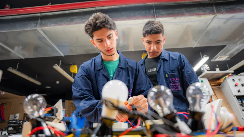 young men working on an electronics apparatus 