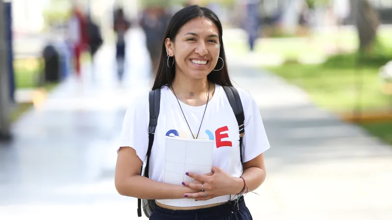 Smiling young woman wearing a school uniform