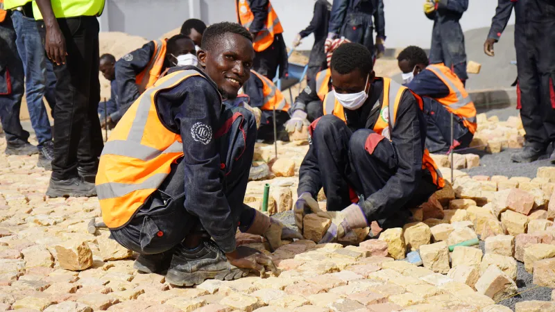 Students paving the fresh produce market with cobblestone in Turkana