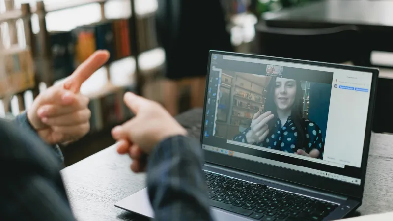 Person using sign language on an online meeting