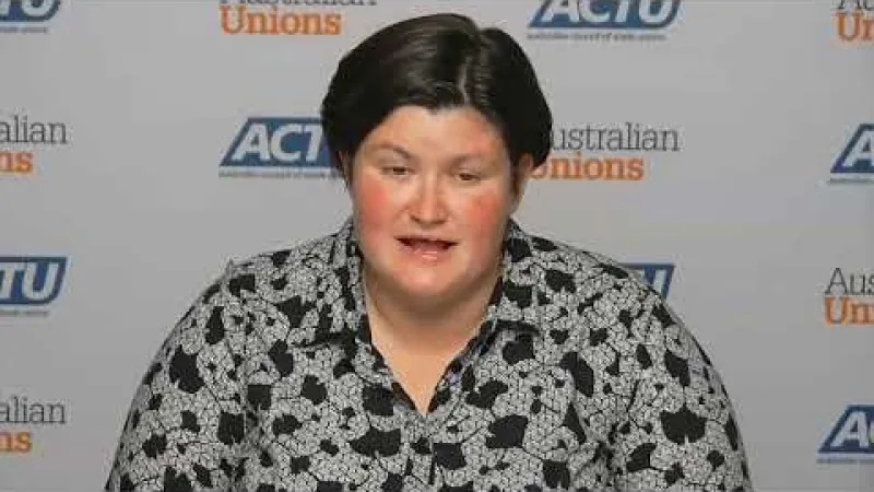 An interview participant in front of an Australian Council of Trade Unions backdrop.